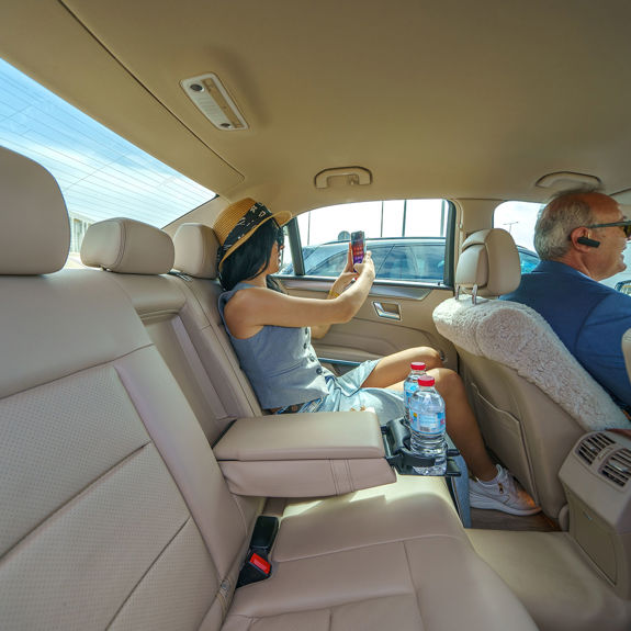 Passenger taking photo from taxi back seat during transfer from Heraklion Airport, comfortable private ride service in Crete
